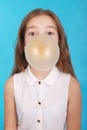 Girl blowing a big bubble gum bubble Royalty Free Stock Photo