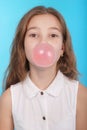 Girl blowing a big bubble gum bubble Royalty Free Stock Photo