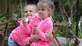 Girl blowing bubbles, suddenly her arms around the other girl