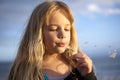 Girl blowing dandelion