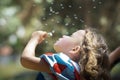 Girl blowing dandelion Royalty Free Stock Photo