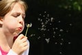 Girl blowing dandelion