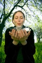 girl blowing dandelion seeds