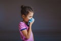 Girl blowing his nose into a handkerchief isolated