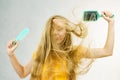 Girl blowing hair with comb brush Royalty Free Stock Photo