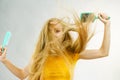 Girl blowing hair with comb brush Royalty Free Stock Photo