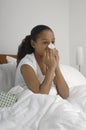 Girl Blowing Nose In Bed Royalty Free Stock Photo