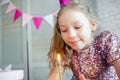 Girl blowing out candles on birthday cake Royalty Free Stock Photo