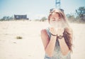 Girl blowing sand