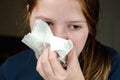 The girl blows her nose into a napkin. Portrait of a teenage girl who fell ill and blows her nose into a napkin Royalty Free Stock Photo