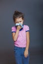 Girl blows her nose wrinkled and a handkerchief Royalty Free Stock Photo