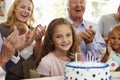Girl Blows Out Birthday Cake Candles At Family Party Royalty Free Stock Photo