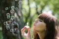 Girl blows soap bubbles