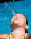 Girl blows a water spout while swimming Royalty Free Stock Photo