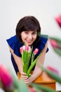 Girl in a blue blouse among the spring flowers Royalty Free Stock Photo