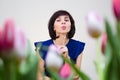 Girl blue blouse among the spring flowers Royalty Free Stock Photo