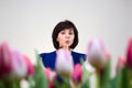 Girl in a blue blouse among the spring flowers Royalty Free Stock Photo