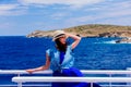 Girl in blue dress and hat have a voyage on a boat Royalty Free Stock Photo