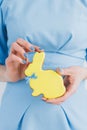 Girl in a blue dress holds Easter ginger cookies