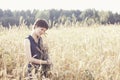 Girl in blue dress hug armful of wheat Royalty Free Stock Photo