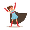 Girl In Blue Dress Pretending To Have Super Powers Dressed In Superhero Costume With Black Cape And Mask Smiling