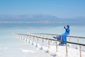 Girl in a blue dress on the shores of the dead sea in Israel on a sunny day Royalty Free Stock Photo