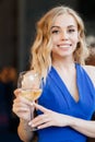 Girl in blue dress standing with glass of wine Royalty Free Stock Photo