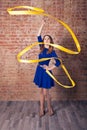 Girl with blue dress, yellow ribbon Royalty Free Stock Photo