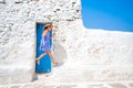 Girl in blue dresses having fun outdoors on Mykonos streets Royalty Free Stock Photo