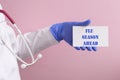 A girl in blue gloves holds a sign flu season ahead Royalty Free Stock Photo