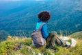 girl in a blue jacket with a hood and a city backpack in the Adygea mountains, Russia