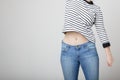 Girl in blue jeans and a striped sweater and raised her hand bar Royalty Free Stock Photo