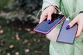 A girl with blue nails holds in her hands a phone in a case and a power bank for charging. Royalty Free Stock Photo