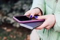 A girl with blue nails holds in her hands a phone in a case and a power bank for charging. Royalty Free Stock Photo