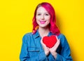 Girl in blue shirt holding a red heart shape box Royalty Free Stock Photo