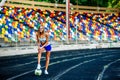 Girl in blue shorts workout on stadium