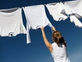 Girl, blue sky and white laundry