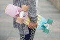 Girl in boho clothes holding cruiser skateboard