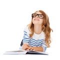 Girl with book and eyeglasses lying on the floor Royalty Free Stock Photo