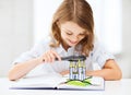 Girl with book looking to castle through magnifier