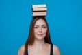 Girl with books on the head Royalty Free Stock Photo