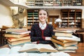 Girl with Books in the Library Royalty Free Stock Photo