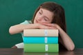 Girl With Books Sleeping At Desk Royalty Free Stock Photo