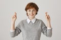 Girl boost confidence with crossed fingers. Portrait positive and focused on victory redhead woman showing wishing