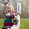 Girl bottle feeding lamb