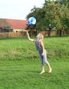 Girl bouncing inflating ball Royalty Free Stock Photo