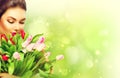 Girl with a bouquet of colorful tulip flowers