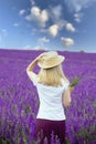 A girl with a bouquet of flowers in a lilac  blooming field. Royalty Free Stock Photo