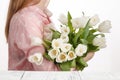 Girl with a bouquet of freshly bestowed tulips