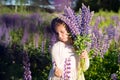 Girl with a bouquet in the hands.portrait of cute little happy seven year old kid girl with bloom flowers lupines in Royalty Free Stock Photo